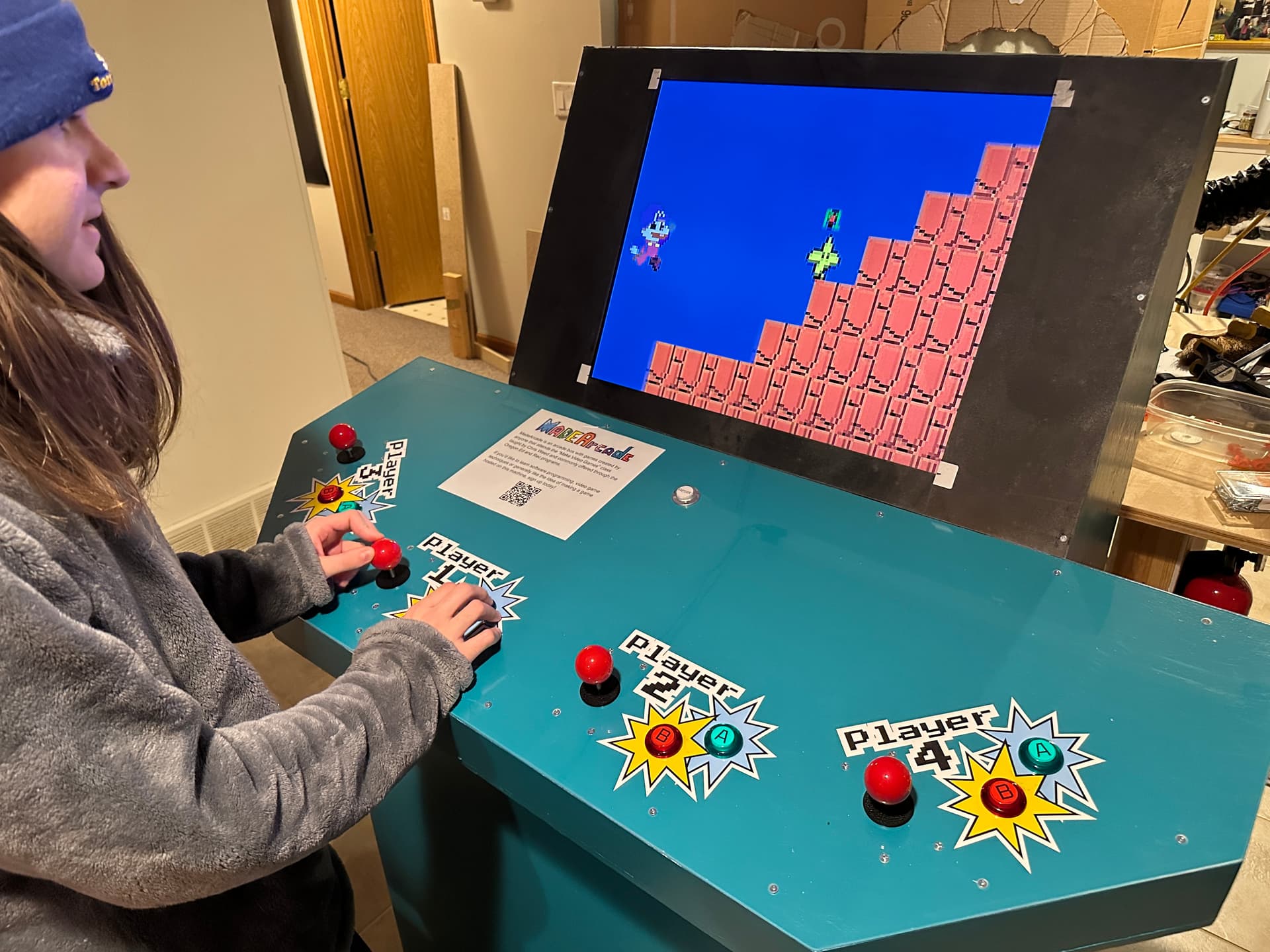 A student playing a game on the 4-player arcade machine